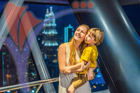 Mom And Son Are Looking At Kuala Lumpur Cityscape. Panoramic View of Kuala Lumpur City Skyline Evening At Sunset Skyscrapers Building in Malaysia. Traveling With Kids Concept