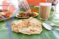 Roti Canai Or Paratha Served On Banana Leaf