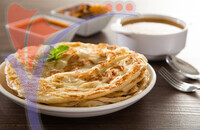 Roti Parata Or Roti Canai With Lamb Curry Sauce.